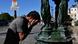 A man splashes water in his face at a fountain, Paris, France A man splashes water in his face at a fountain, Paris, France