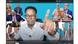 Ayub Abdirizak sitting in front of a picture wall with a raised finger