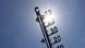 A thermometer against a cloudless, sunny sky A thermometer against a cloudless, sunny sky