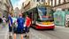 Three men stand on the road in Prague next to an unpowered tram Three men stand on the road in Prague next to an unpowered tram