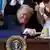 US President Donald Trump uses a gavel after signing the sweeping spending and tax legislation, known as the "One Big Beautiful Bill Act," at the White House on July 4, 2025