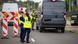 Police in yellow safety vests conduct controls at the German-Polish border, a van and several temporary road signs can be seen Police in yellow safety vests conduct controls at the German-Polish border, a van and several temporary road signs can be seen