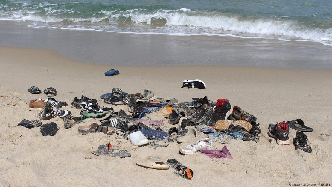 Shoes of immigrants are pictured on the beach, who died after their boat capsized