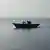 A wooden boat carrying North Korean individuals move northward in the East Sea