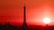The Eiffel Tower and Sacré-Cœur silhouetted against a deep red sunrise sky during a heatwave in Paris, France. The Eiffel Tower and Sacré-Cœur silhouetted against a deep red sunrise sky during a heatwave in Paris, France.