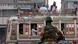 A soldier stands guard as a bus passes in Karachi, Pakistan. A soldier stands guard as a bus passes in Karachi, Pakistan.