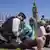 Police officers arrest protesters in Parliament Square who were holding placards in support of Palestine Action