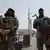 Syrian government security forces stand guard on their checkpoint at one of Jaramana suburb entrances, after clashes in the area between members of the minority Druze sect and pro-government fighters, in the southern suburb of Jaramana, Damascus, Syria, Wednesday, April 30, 2025