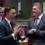 Laurent Saint-Martin and Maros Sefcovic, two suited men talking, one with hands raised, fingers pointing upward