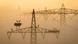Storks seen nesting on a transmission tower in the early morning fog Storks seen nesting on a transmission tower in the early morning fog