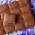 Açık bir paket Milka çikolatası görülüyor