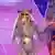 Beyonce makes a hand gesture as she performs in a glittery costume and a hat during the UK leg of the Cowboy Carter tour on June 5, 2025