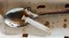 A metal spoon filled with brown liquid heroin and a syringe. A metal spoon filled with brown liquid heroin and a syringe.