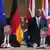 Britain's Prime Minister Keir Starmer, seated right, and German Chancellor Friedrich Merz, seated left, with Germany's Minister for Foreign Affairs Johann Wadephul, behind left, and Britain's Foreign Secretary David Lammy, behind right