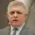 Head shot of a man (Robert Fico) with short gray hair in a pale gray pinstriped suit, Handlova, Slovakia, May 15, 2025