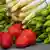 Green and white asparagus and strawberries on a wooden table