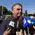 Brazil's former President Jair Bolsonaro speaks to the press outside the Secretariat of Penitentiary Administration where he arrived after the Supreme Court ordered him to be fitted with an electronic ankle monitor