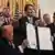 US President Donald Trump holds the signed "Genius Act," which will develop regulatory framework for stablecoin cryptocurrencies and expand oversight of the industry, at the White House in Washington, DC, US