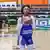 Djelika Tounkara, wearing a blue and white shirt, holds a basketball with both hands
