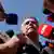 Brazil's former President Jair Bolsonaro speaks to the press after the Supreme Court ordered him to be fitted with an electronic ankle monitor in Brasilia on July 18, 2025
