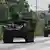 Royal Thai Army soldiers are pictured on armoured vehicles on a road in Chachoengsao province on July 24, 2025