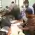 Officers verify voters' documents during Bihar's special intensive revision (SRI) of electoral rolls on July 13, 2025 in Patna, India