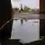 In Zimbabwe, a young man is seen in the distance walking alone
