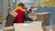 Workers in the DHL logistics center in Dresden sorting parcels Workers in the DHL logistics center in Dresden sorting parcels