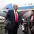 US President Donald Trump stands on the tarmac at Prestwick Airport in Ayrshire, Scotland as journalists hold up microphones on July 25, 2025.