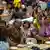 Hundreds of internally displaced Thai nationals sit in a temporary evacuation area and receive aid inside Surin's s Rajaphjat University gymnasium
