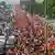 Hindu pilgrims wearing orange pack road in Haridwar, Uttarakhand