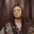 Distraught-looking Iryna Krynina sits in a chair, gazing away from the camera