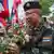 A soldier is accepting roses from a group of royalists in Bangkok