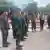 Thai (left) and Cambodian (right) military commanders meet on a bridge at the border
