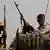 Sudanese soldiers from the Rapid Support Forces unit hold weapons as they secure an area