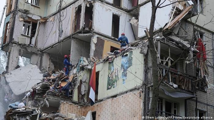 Rescuers search for survivors in a damaged apartment building in Kyiv after a <a data-mil=