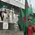 A Bangladeshi man carrying country's flags standing on a street in Dhaka