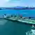 A ship loaded with oil docks at a pier with the help of a tugboat at the port of Qingdao, in  Shandong province, China on June 12, 2025