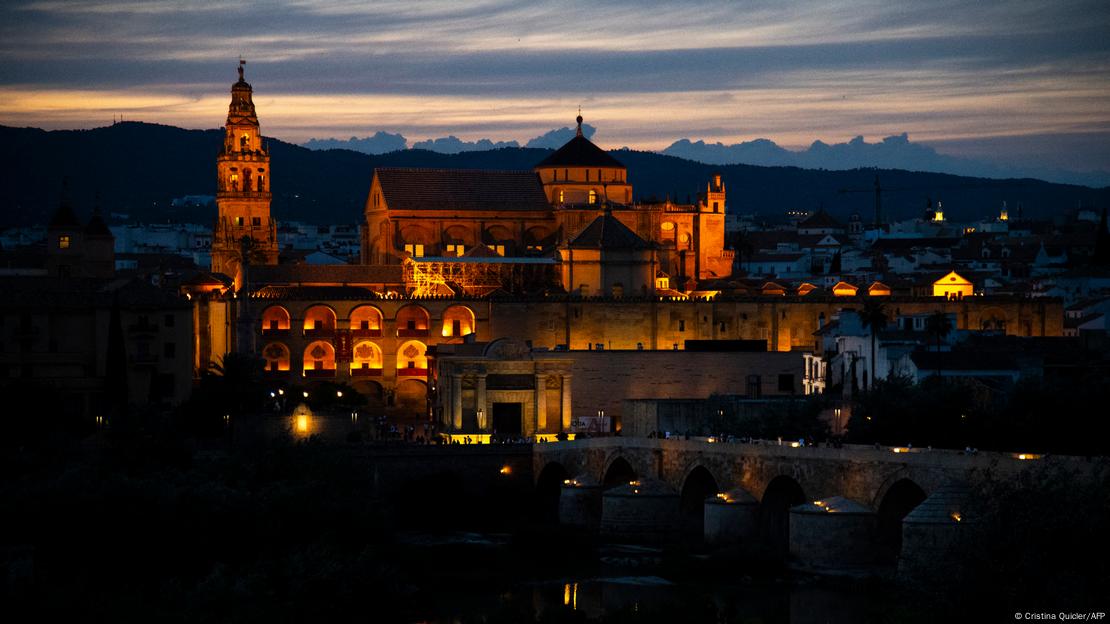 The Mosque-Cathedral of Cordoba is illuminsted against the skyline in Spain.