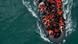 In this drone view an inflatable dinghy carrying migrants makes its way towards England in the English Channel In this drone view an inflatable dinghy carrying migrants makes its way towards England in the English Channel