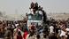 Palestinians scramble to collect aid supplies from a truck Palestinians scramble to collect aid supplies from a truck