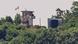 This photo shows a North Korean soldier standing guard in a watch tower next to a giant loudspeaker (R), near the Demilitarized Zone (DMZ) dividing the two Koreas This photo shows a North Korean soldier standing guard in a watch tower next to a giant loudspeaker (R), near the Demilitarized Zone (DMZ) dividing the two Koreas