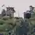 This photo shows a North Korean soldier standing guard in a watch tower next to a giant loudspeaker (R), near the Demilitarized Zone (DMZ) dividing the two Koreas