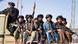 Muyahidines fuertemente armados sentados en la parte trasera de una camioneta durante el desfile para celebrar el tercer aniversario de la toma del poder por los talibanes en Kandahar, el 14 de agosto del año pasado. Muyahidines fuertemente armados sentados en la parte trasera de una camioneta durante el desfile para celebrar el tercer aniversario de la toma del poder por los talibanes en Kandahar, el 14 de agosto del año pasado.