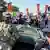 Metropolitan Police officers and military police soldiers with the District of Columbia National Guard watch as activists protest President Donald Trump's federal takeover of policing of the District of Columbia on August 16, 2025