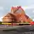 Kiruna's old wooden church sits on a structure relocation rig with wheels for a two-day relocation trip to a new site next to a cemetery, to save its wooden walls from ground subsidence and the expansion of the world's largest underground iron ore mine, in Kiruna, Sweden August 19, 2025