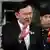 Former Thai Prime Minister Thaksin Shinawatra gestures as he leaves after a Thai criminal court