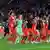 Bayern Munuch players link arms over each others shoulders as the celebrate in a line