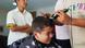 A youth gets his hair cut at a barbershop to adhere to public school rules for hair A youth gets his hair cut at a barbershop to adhere to public school rules for hair