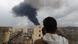 A photojournalist takes a picture of smoke after an Israeli airstrike on Yemen's capital Sanaa A photojournalist takes a picture of smoke after an Israeli airstrike on Yemen's capital Sanaa
